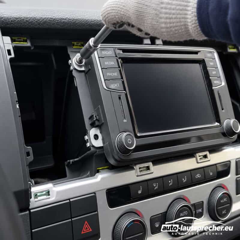 T20-Torx-Schraubendreher an der oberen linken Befestigungsschraube des Werksradios im VW T6 ab 2015.